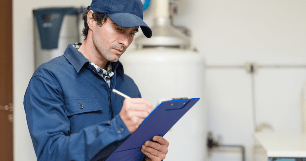 a handyman writing on a blue clipboard