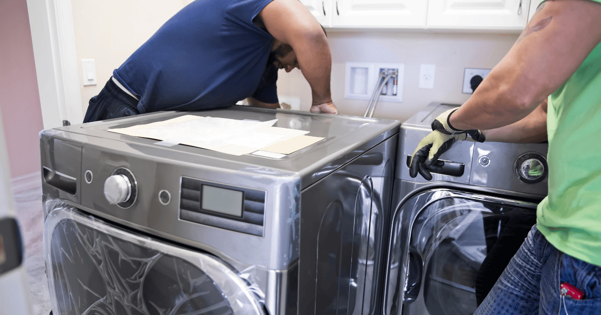 two men installing a new washing machine
